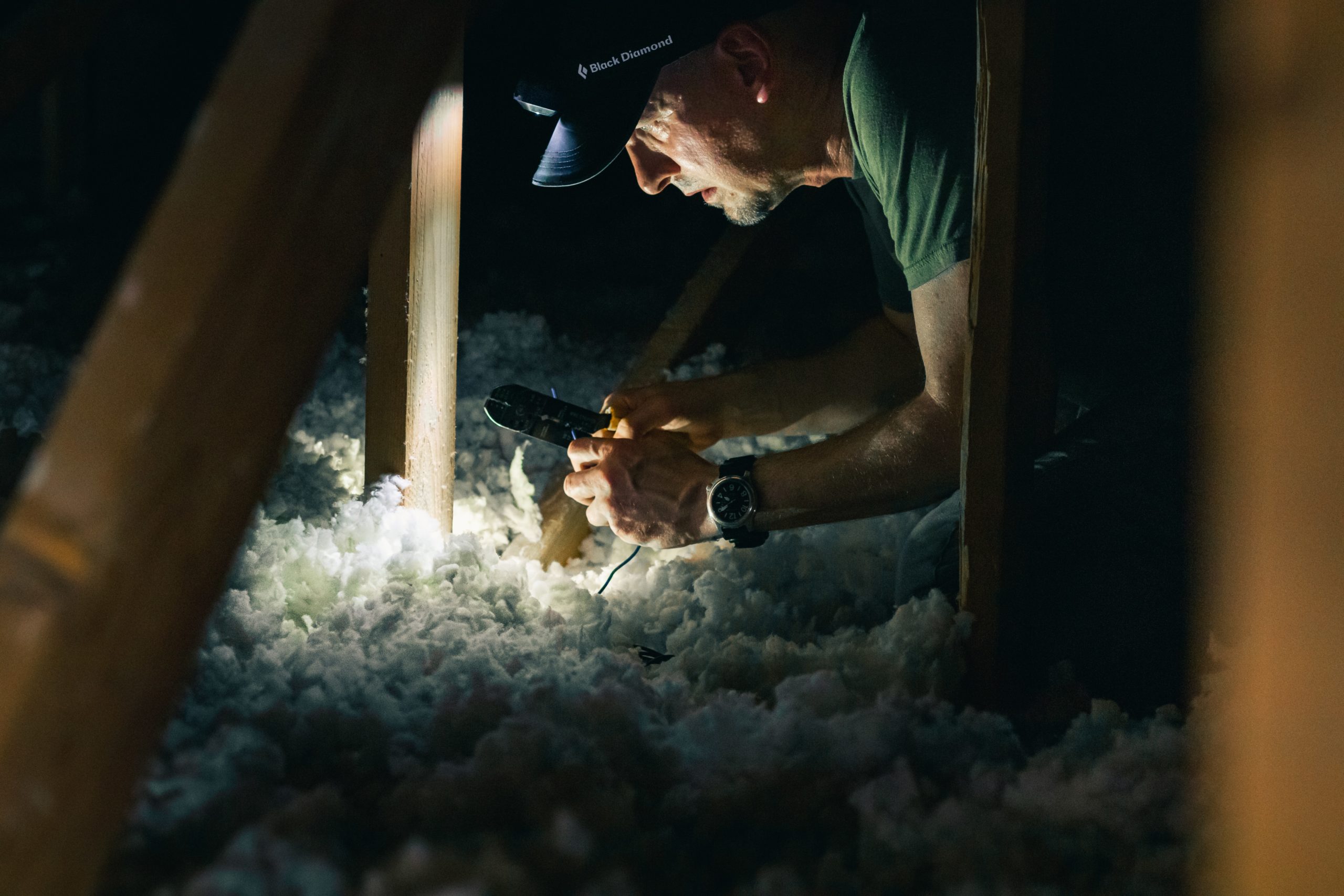 Man inspecting fiberglass insulation